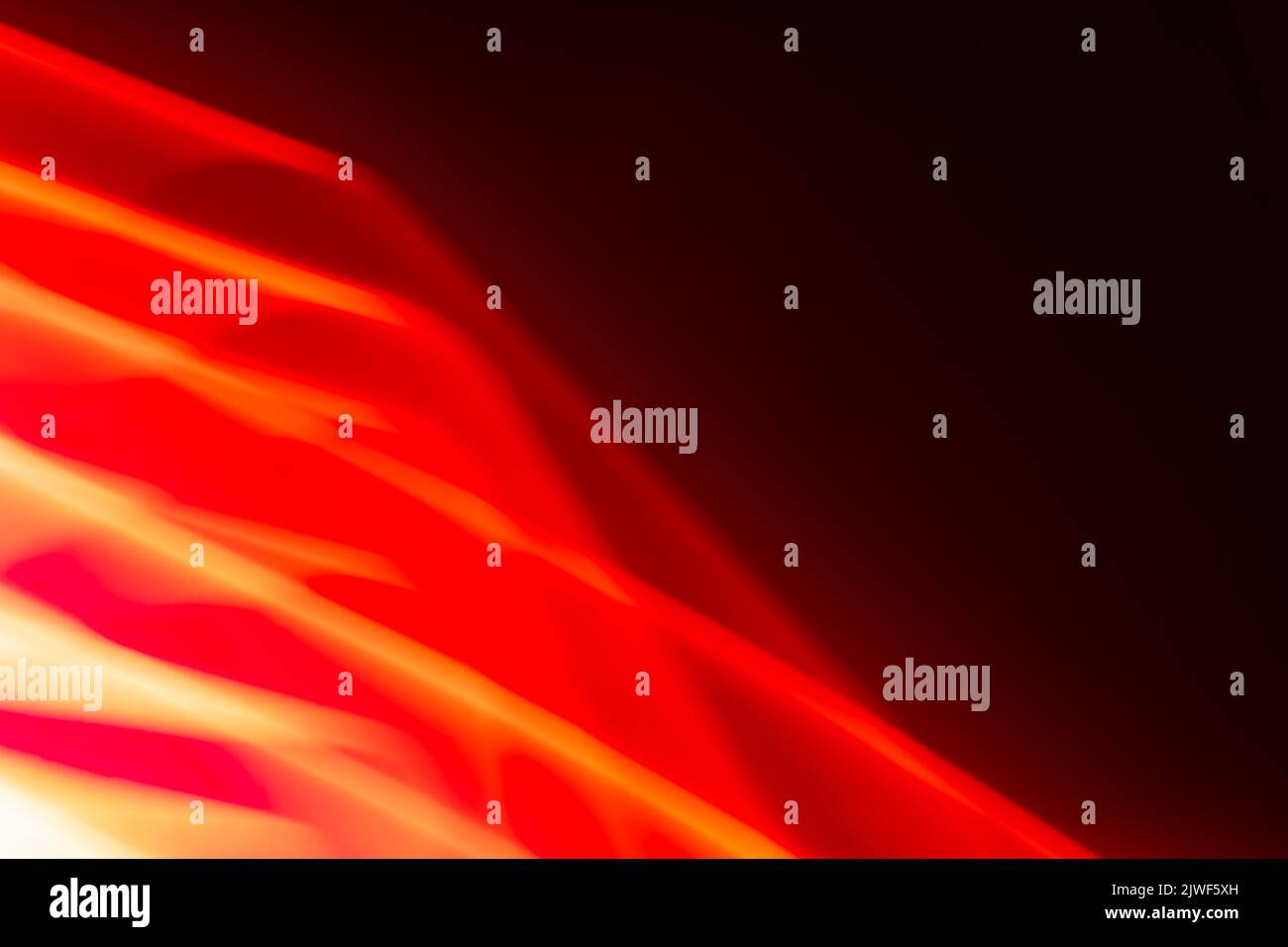 Abstract glowing red waves on a dark background. Banner. Backdrop Stock Photo