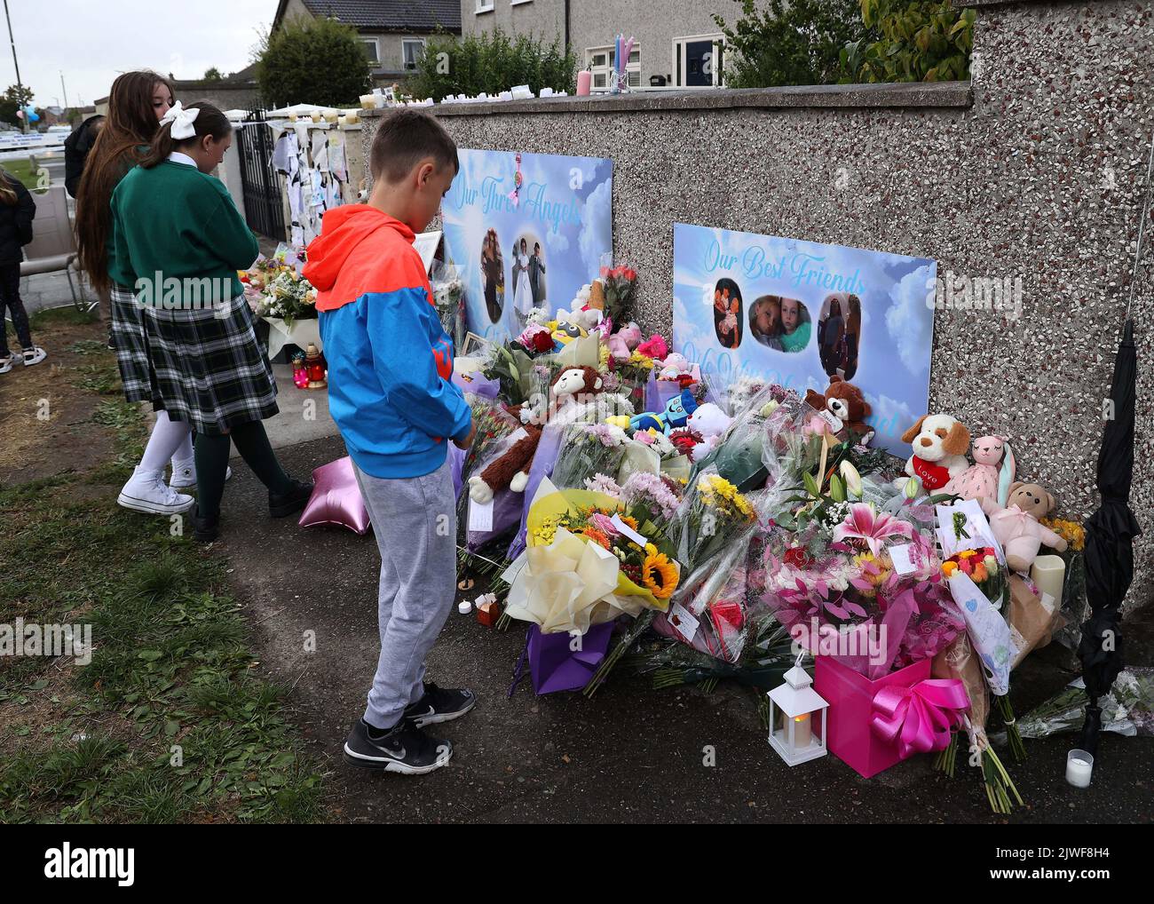 Flowers and candles left after a vigil outside a house on Rossfield