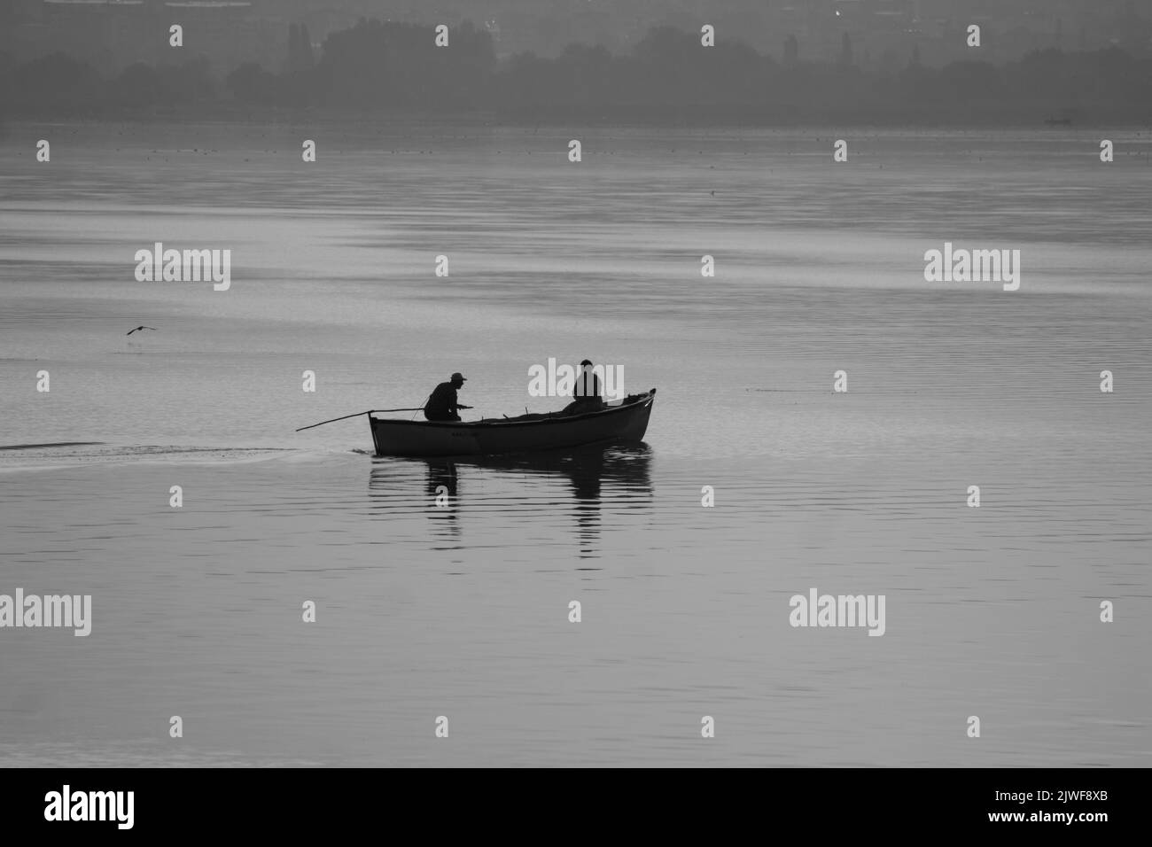 Golyazi, Bursa - August 2022: Fishermen in the lake go fishing with their boats in the early morning, selective focus Stock Photo
