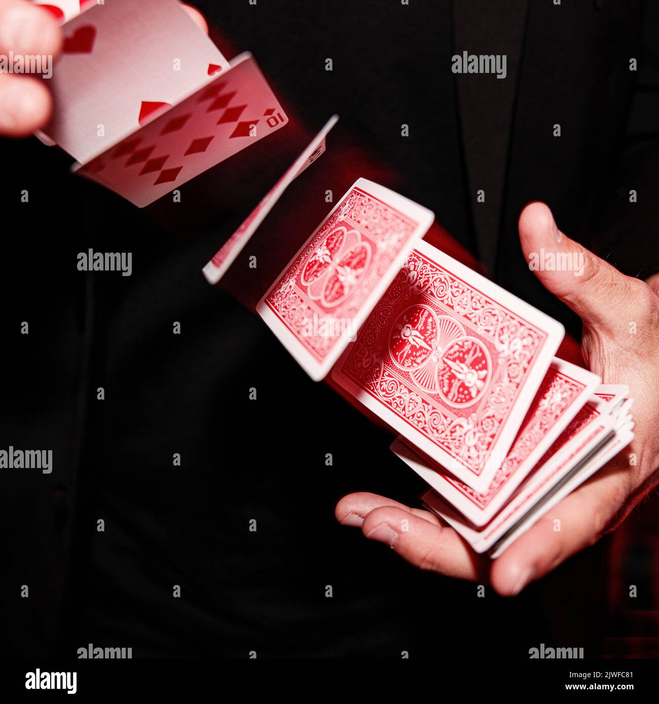 A close up of a cardsharp magician shuffling card Stock Photo