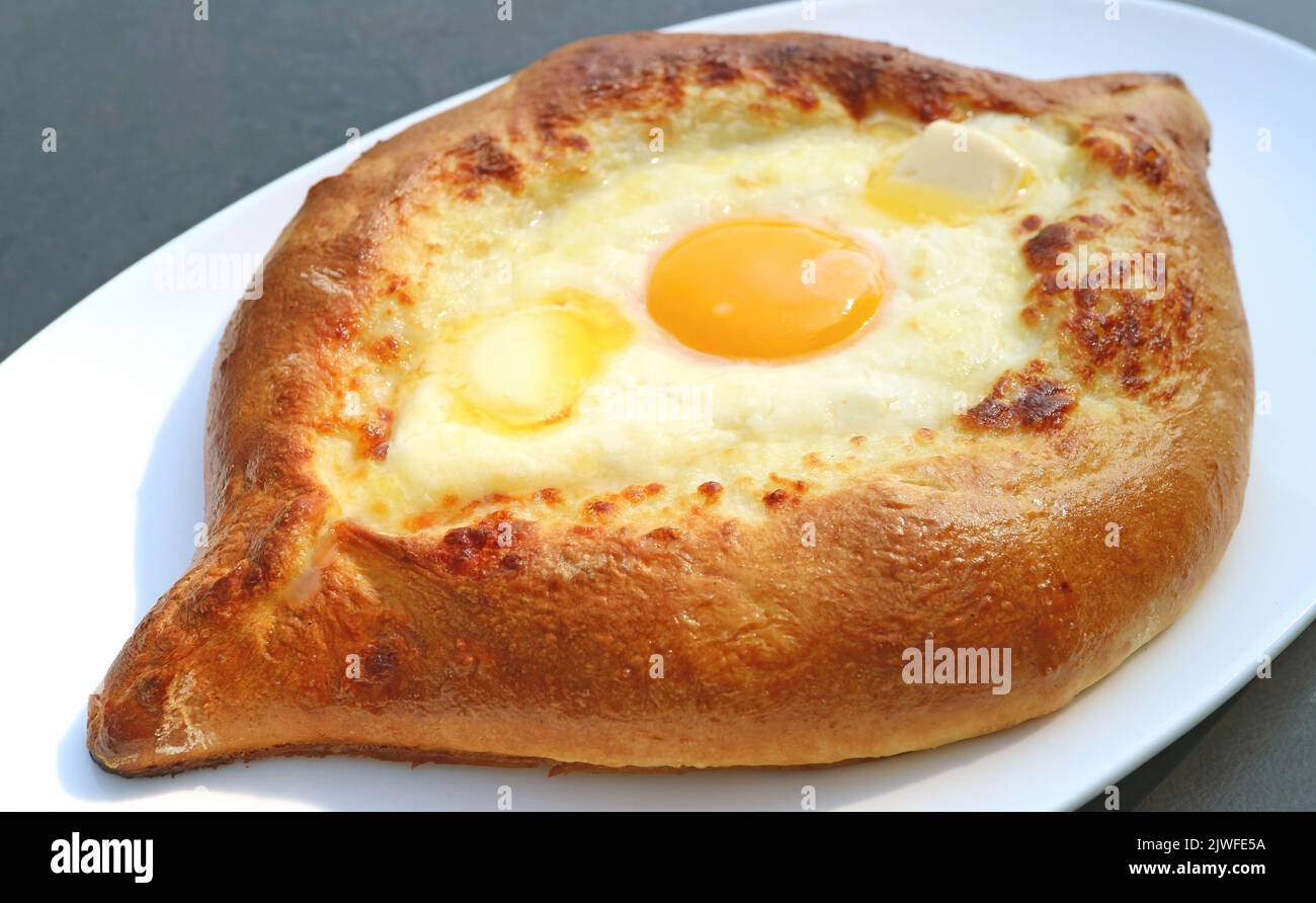 Closeup Freshly Baked Adjarian Khachapuri, Cheese and Egg Filled Traditional Georgian Bread Stock Photo
