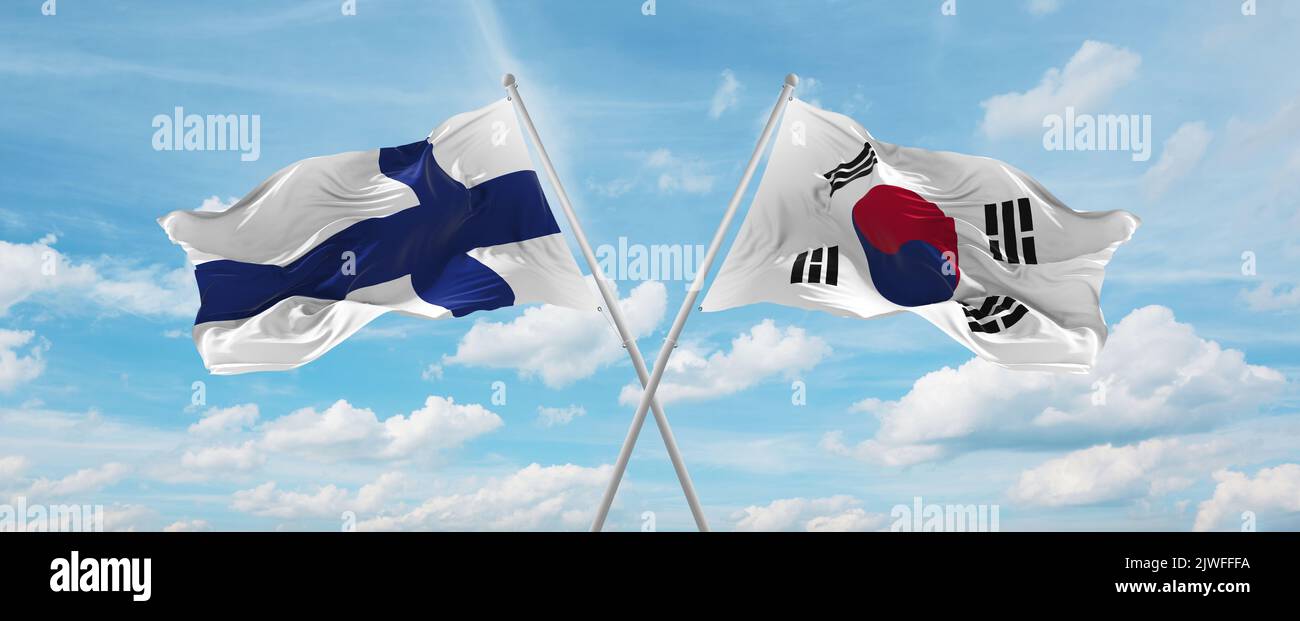 two crossed flags south korea and finland waving in wind at cloudy sky ...