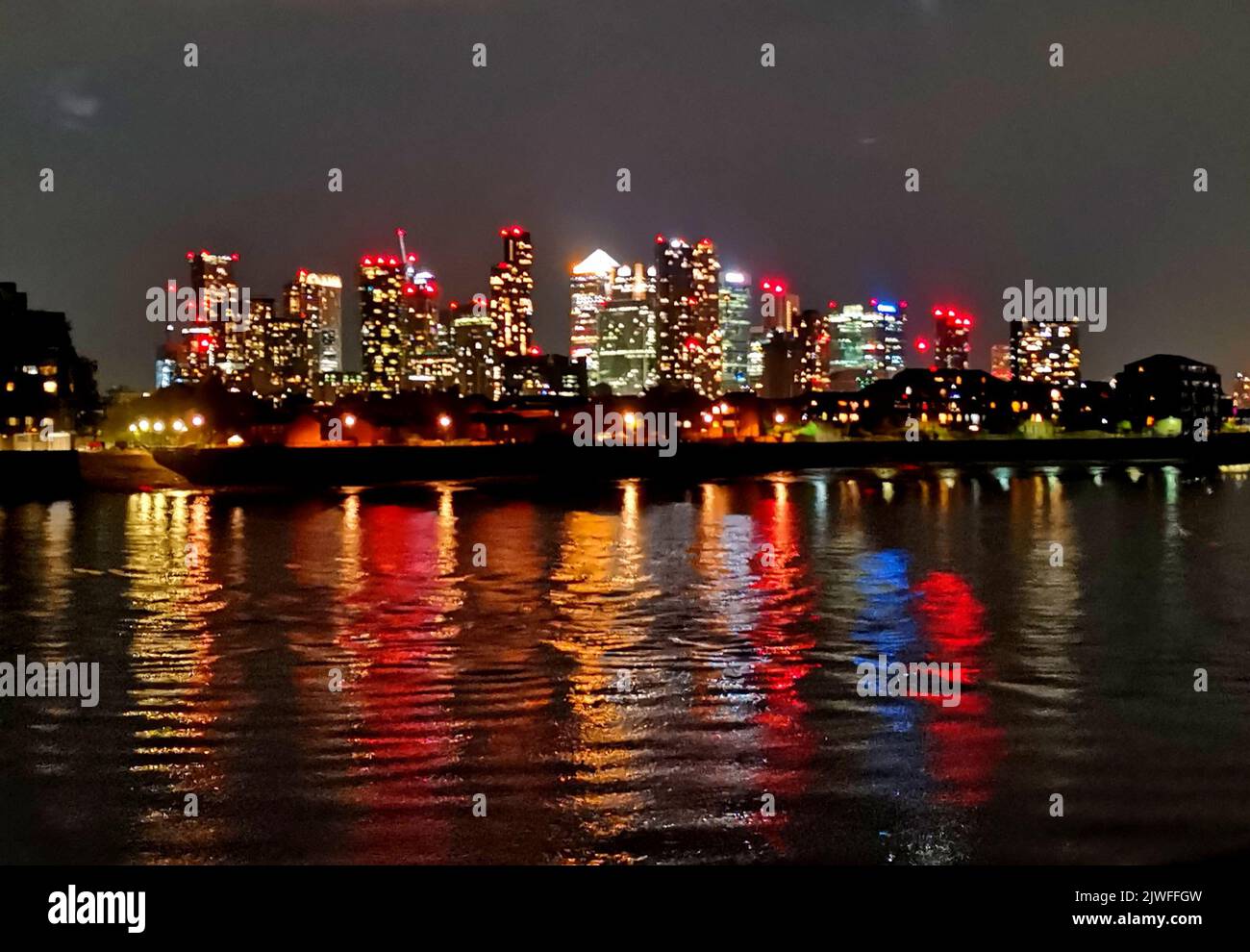 15 August 2022 - London, UK: River Thames with skyline in background at night Stock Photo