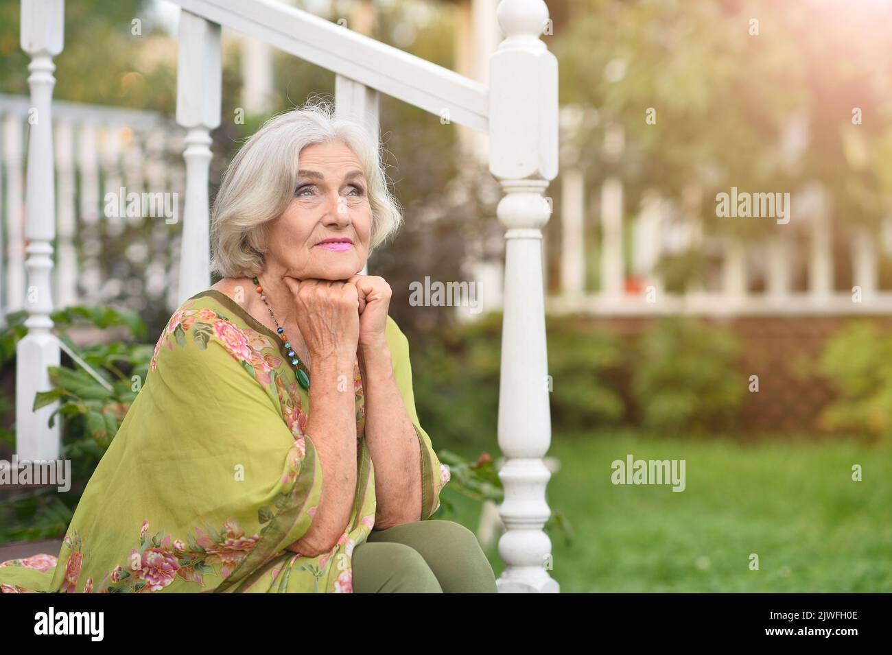Mature woman alone sitting garden hi-res stock photography and images ...