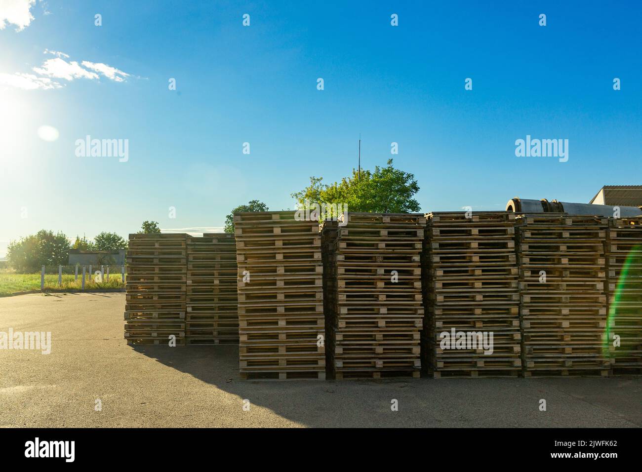 Stacks of wooden pallets in a warehouse yard of factory. Pallets for
