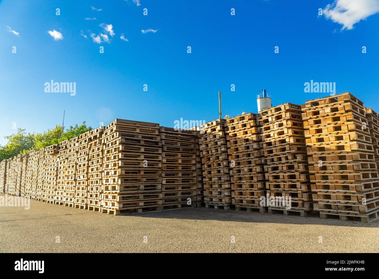 Stacks of wooden pallets in a warehouse yard of factory. Pallets for