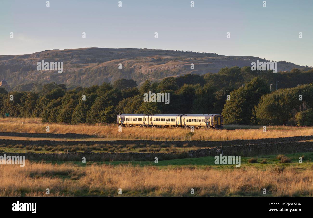 Northern rail class 158 DMU train on the scenic  little north western railway line in Yorkshire passing the countryside at Settle junction Stock Photo