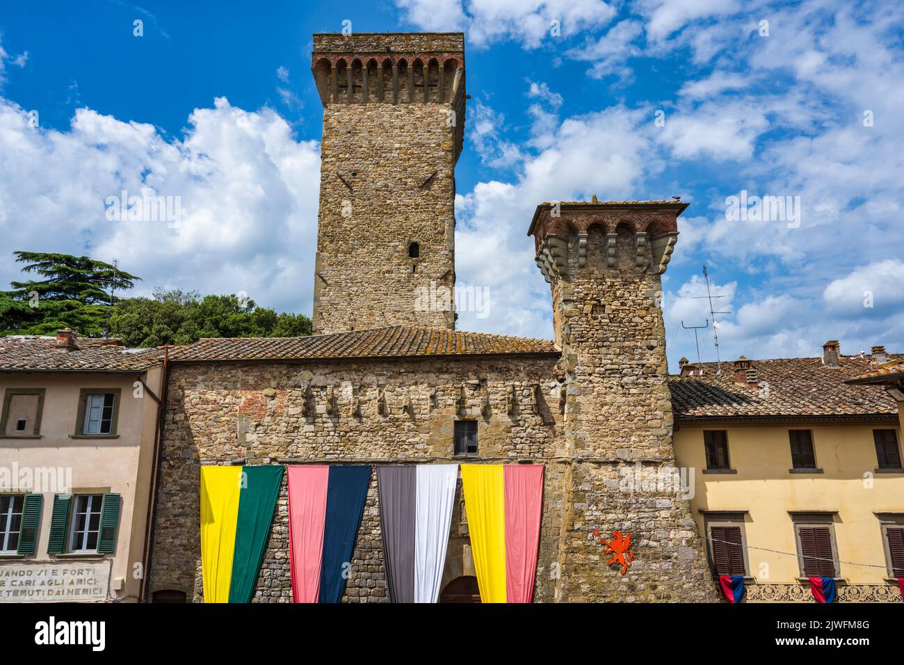 Former Teatro Rosini on Via Roma with Torre della Rocca in background in the medieval hilltop town of Lucignano in the Val di Chiana in Tuscany, Italy Stock Photo