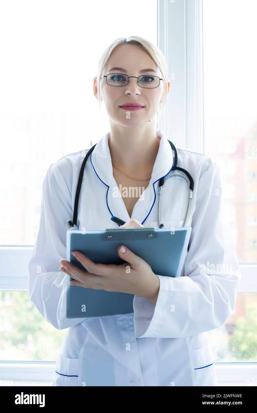 Medical concept of female intern doctor in white coat with stethoscope, Medical student in practice Stock Photo