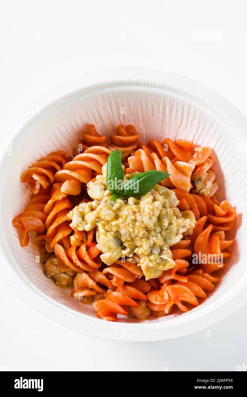 fusilli pasta in tomato sauce with rabbit sauce and fresh basil in a ...