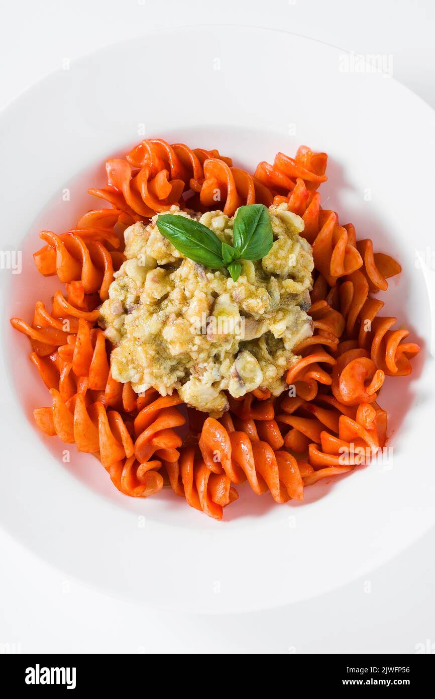 fusilli pasta in tomato sauce with rabbit sauce and fresh basil on ...