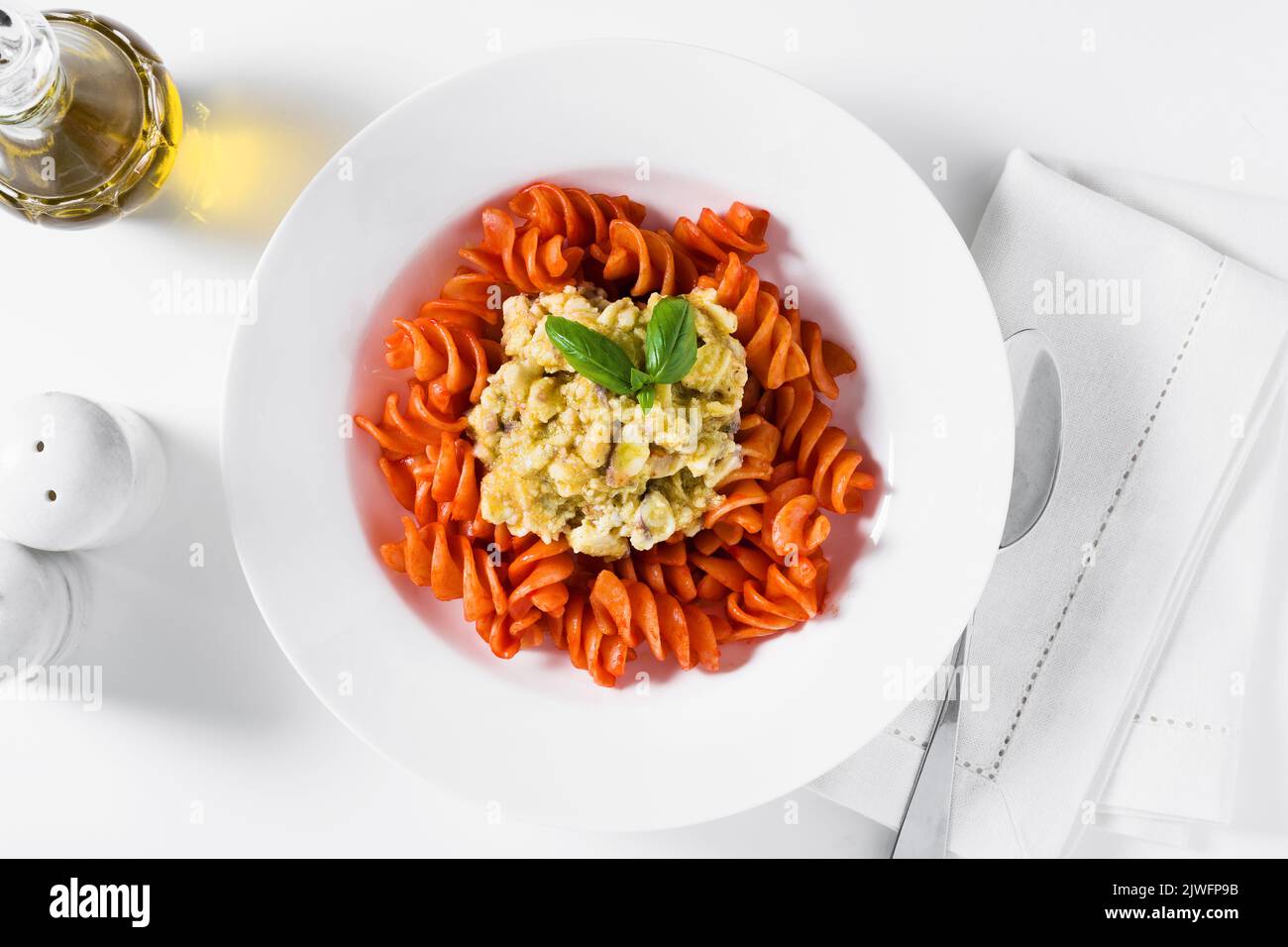 fusilli pasta in tomato sauce with rabbit sauce and fresh basil on ...
