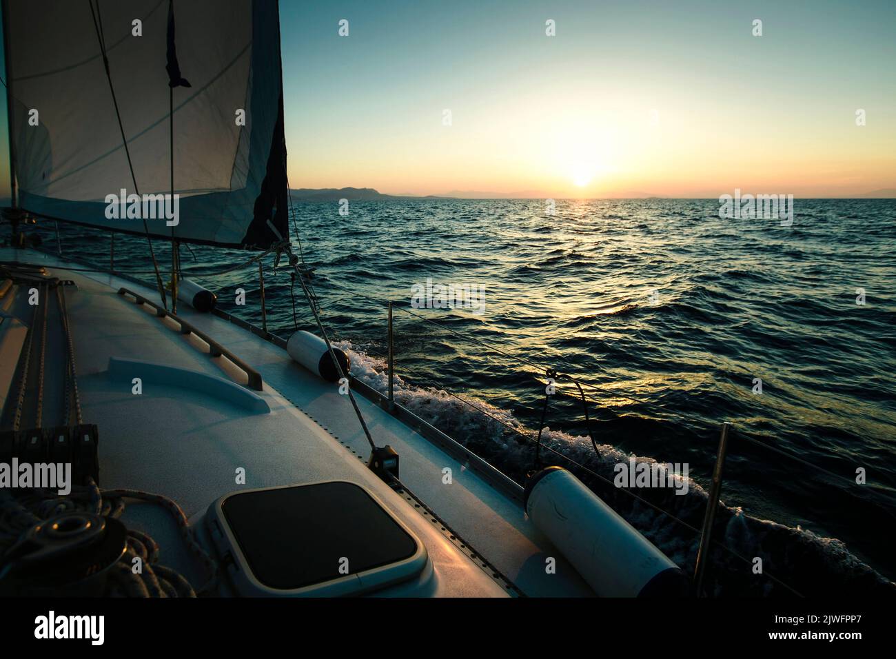 Sailing yacht boat in the Sea during amazing sunset. Stock Photo