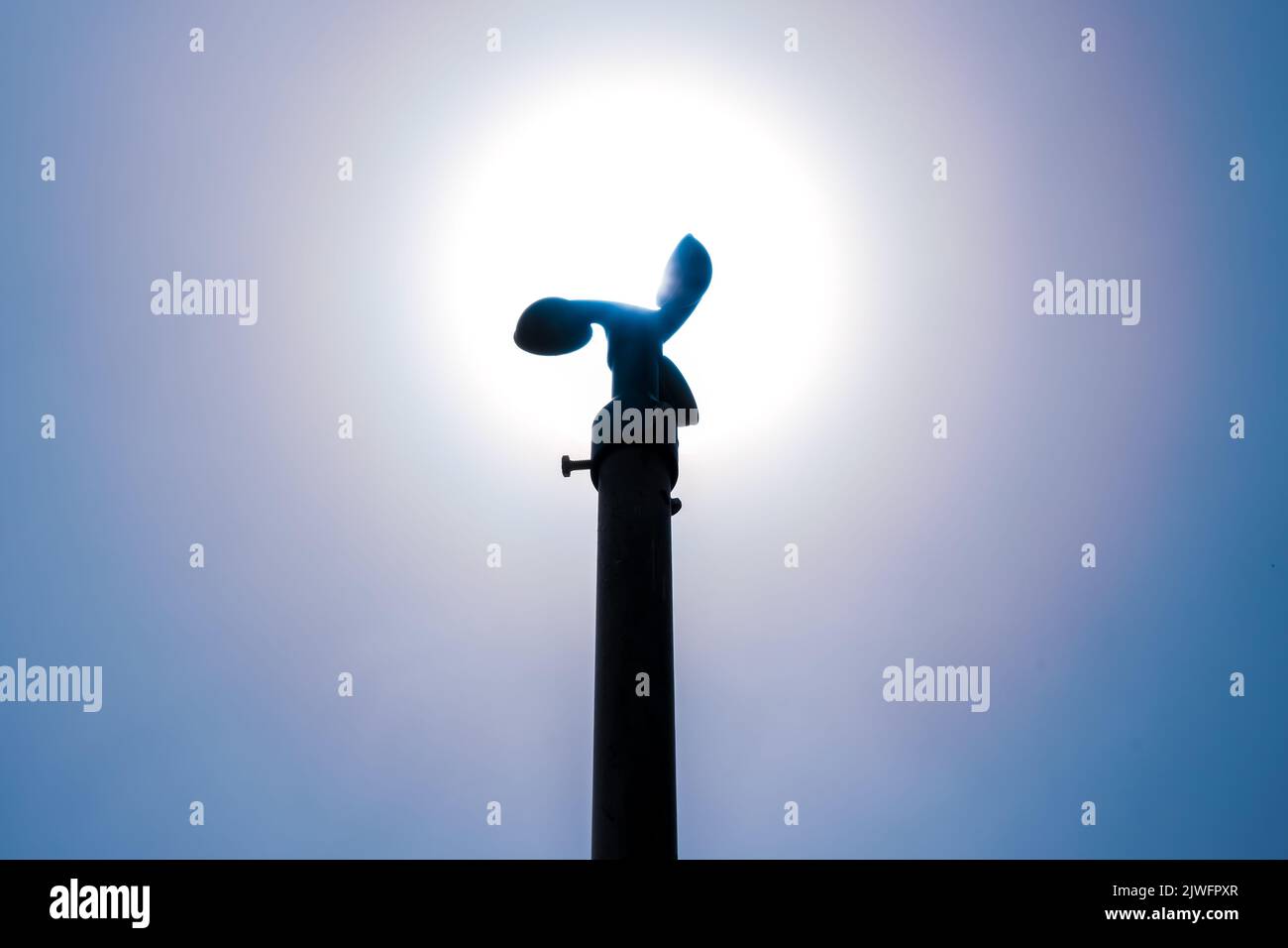 Backlit anemometer on a pole against the blue sky Stock Photo Alamy