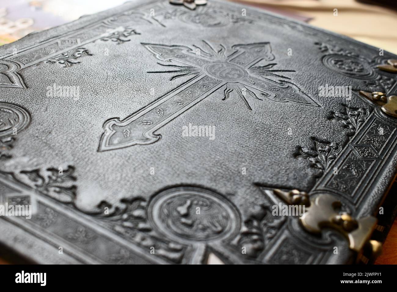 Old Bible with leather cover in black and white with engraved cross