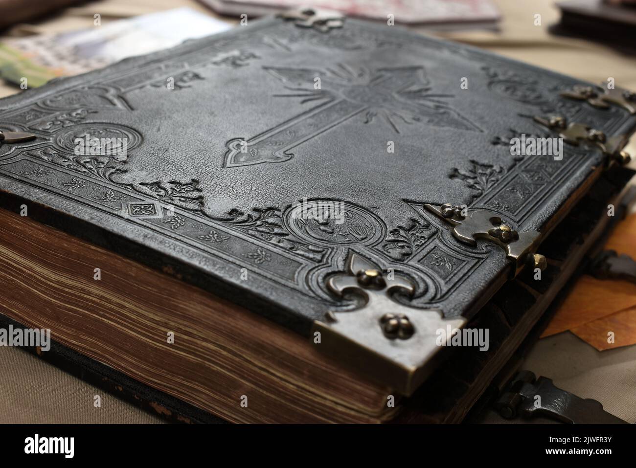 Old Bible with leather cover in black and white with engraved cross