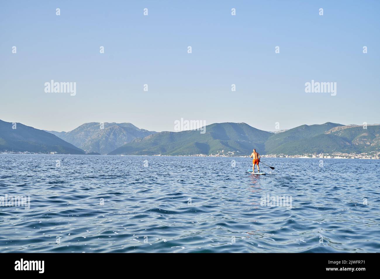 A man swims on a sub board in the Sea Stock Photo