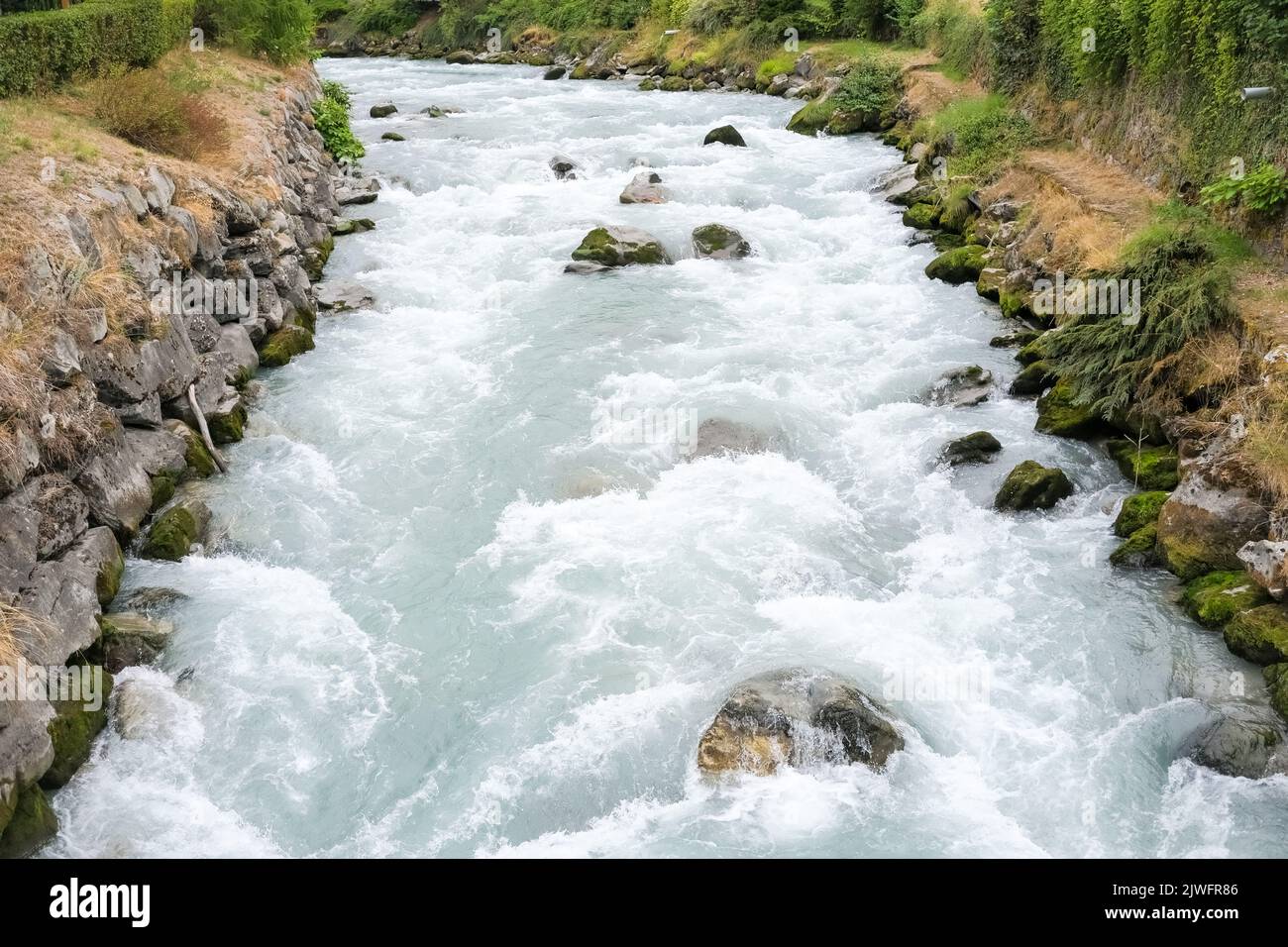 A river goes down rough after collecting white water from the melting ...