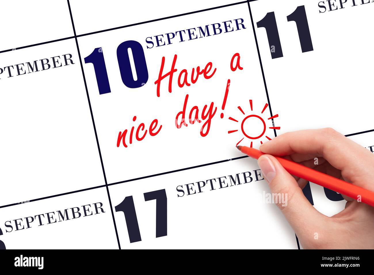 10th day of September. The hand writing the text Have a nice day and drawing the sun on the calendar date September  10. Save the date. Autumn month, Stock Photo
