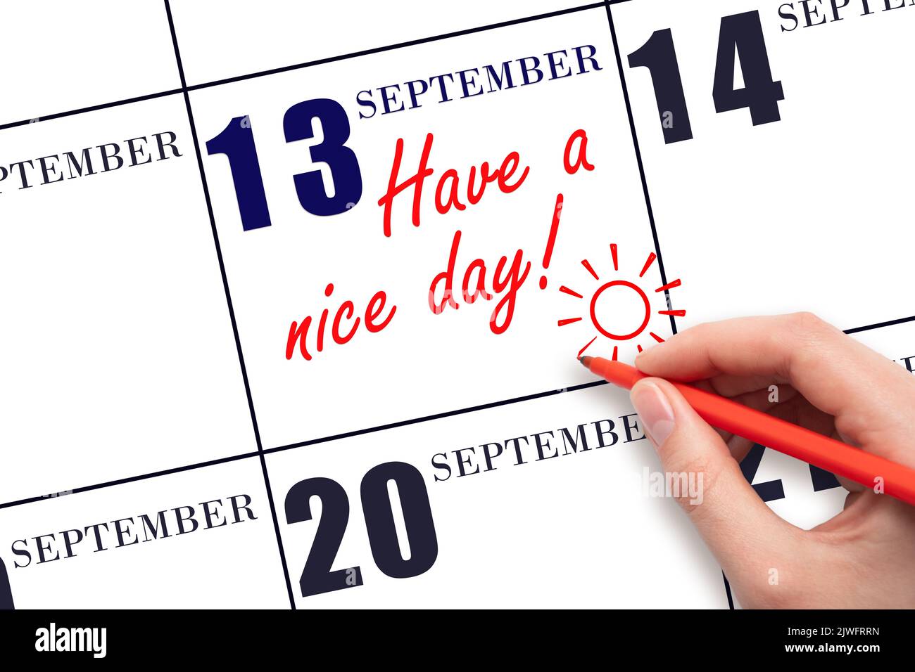 13th day of September. The hand writing the text Have a nice day and drawing the sun on the calendar date September  13. Save the date. Autumn month, Stock Photo