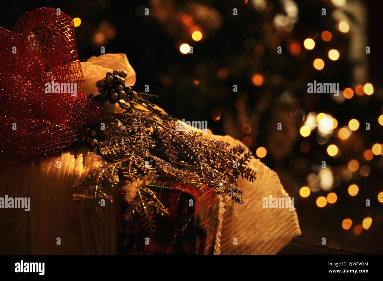 Close up photo on gorgeously wrapped Christmas gift on Christmas night Stock Photo