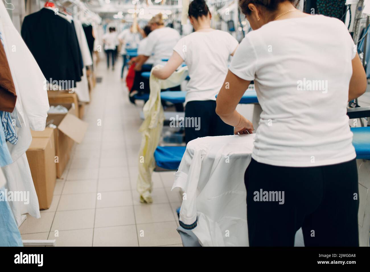Dry cleaning clothes. Clean cloth chemical process. Laundry workers