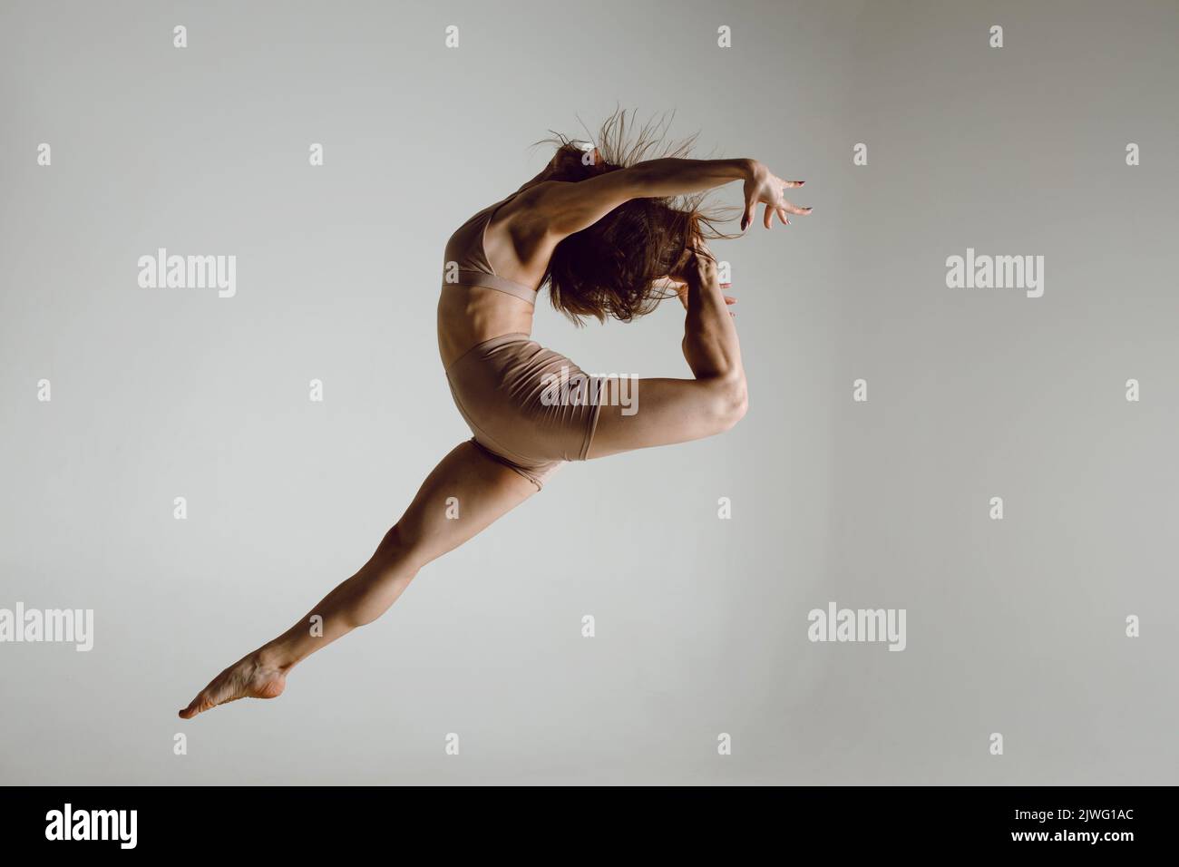 Young woman dancer dancing high heels dance jumping leg-split Stock Photo