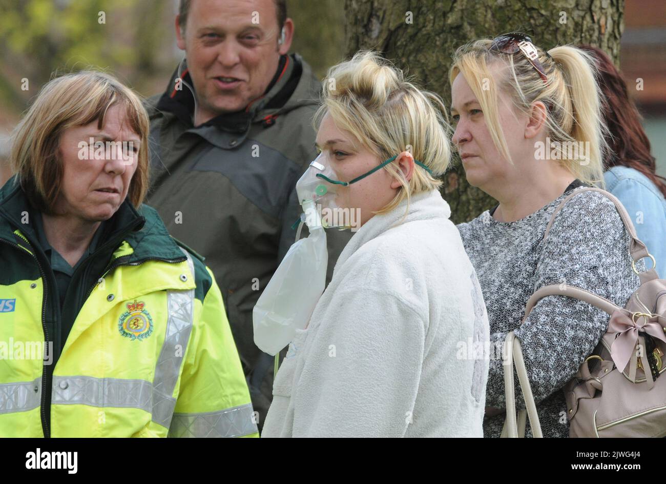 A PARAMEDIC TREATS A RESIDENT FOR SMOKE INHALATION AFTER A FIRE ION THE