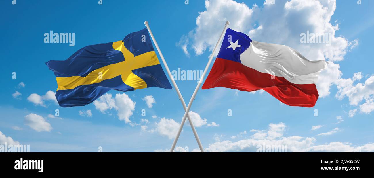 two crossed flags Chile and Sweden waving in wind at cloudy sky ...