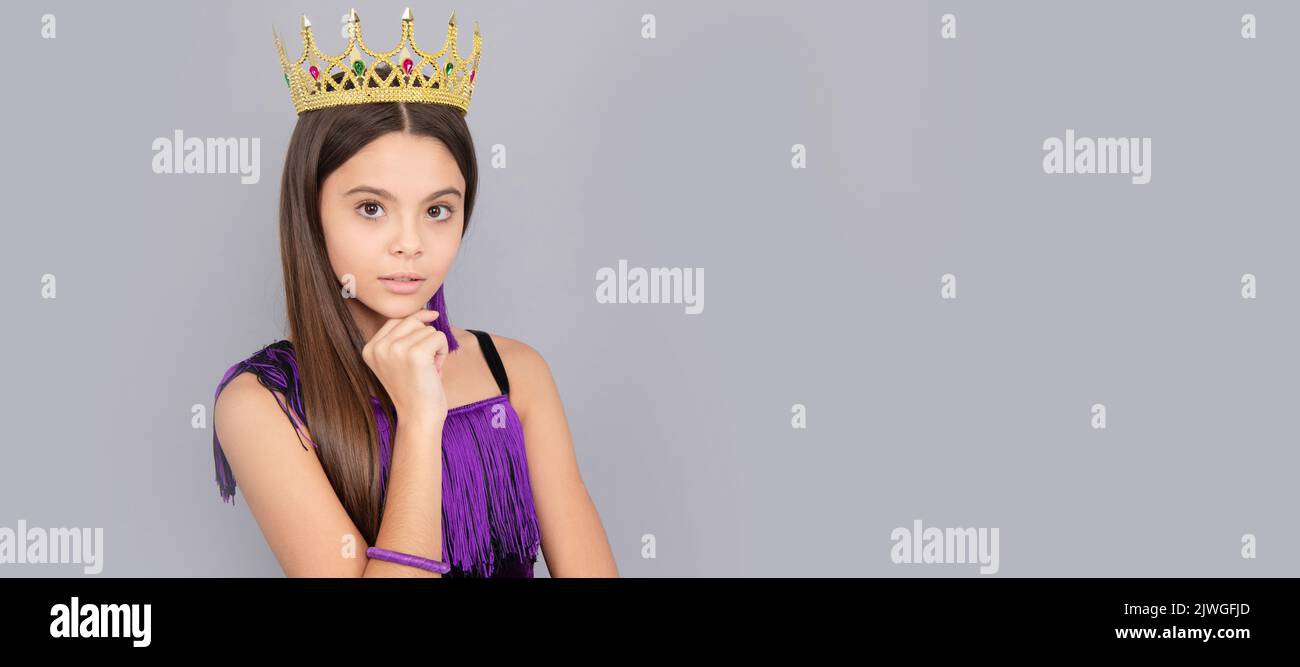 Ambitious girl wear luxury jewelry crown grey background copy space, big boss. Child queen princess in crown horizontal poster design. Banner header Stock Photo