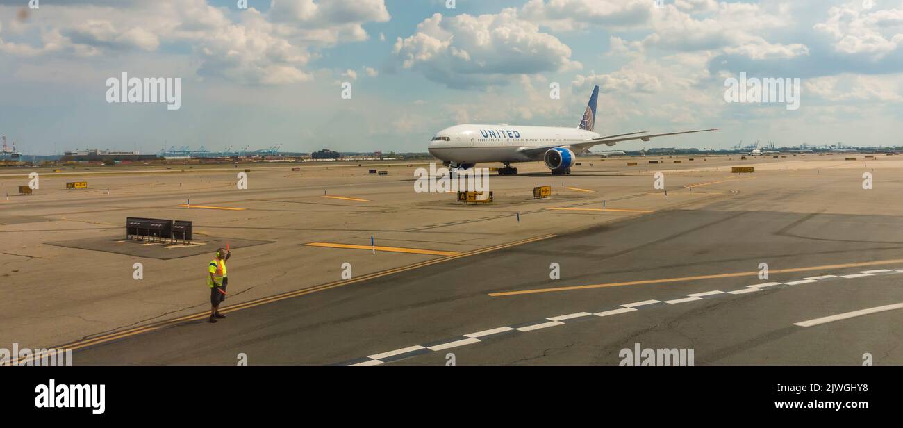 Aircraft marshall and United Airlines plane at airport Stock Photo