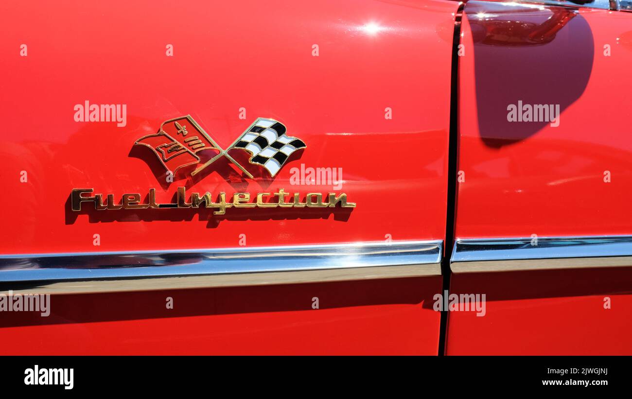 Fuel Injection signage on a red 1957 Chevy Bel Air; Chevrolet flag logo. Stock Photo