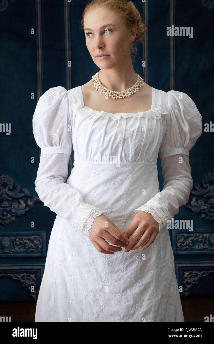 A Regency Woman Wearing A White Embroidered Muslin Gown With A Pearl 