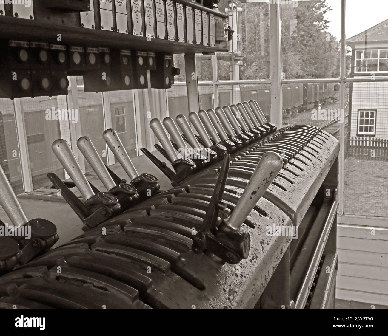 Sepia image of electric signal box levers and frame, Crewe, Cheshire, England, UK, CW1 2DB Stock Photo