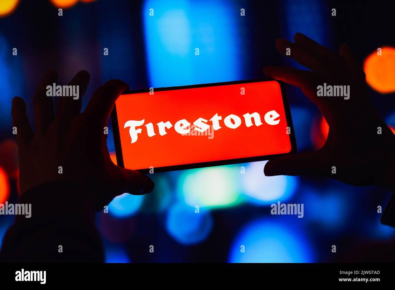 In this photo illustration, the Firestone Tire and Rubber Company logo is displayed on a smartphone screen. Stock Photo