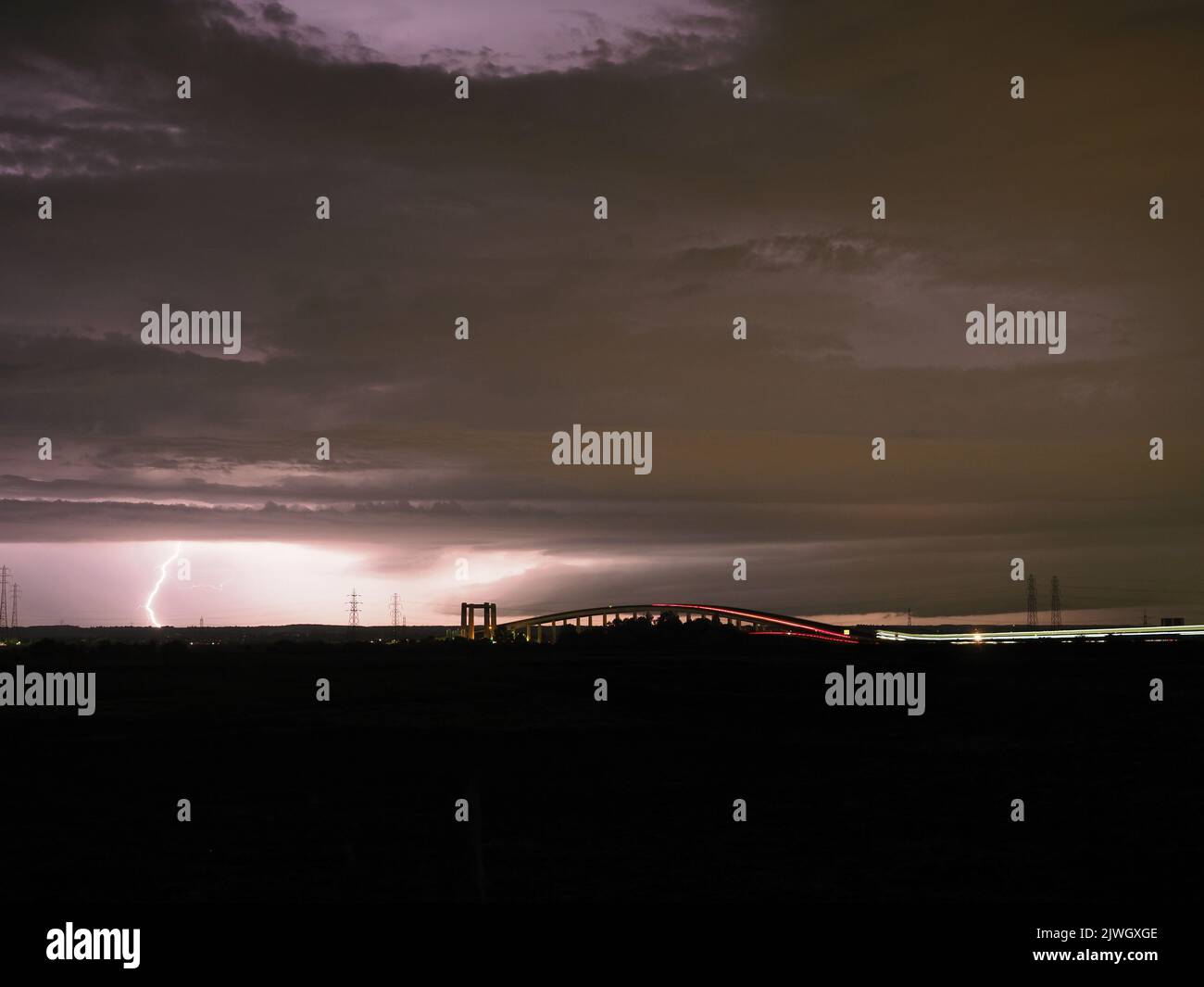 Minster on Sea, Kent, UK. 06th September, 2022. UK Weather: lightning seen near the Sheppey Crossing during a thunderstorm from Minster on Sea, Kent. Credit: James Bell/Alamy Live News Stock Photo