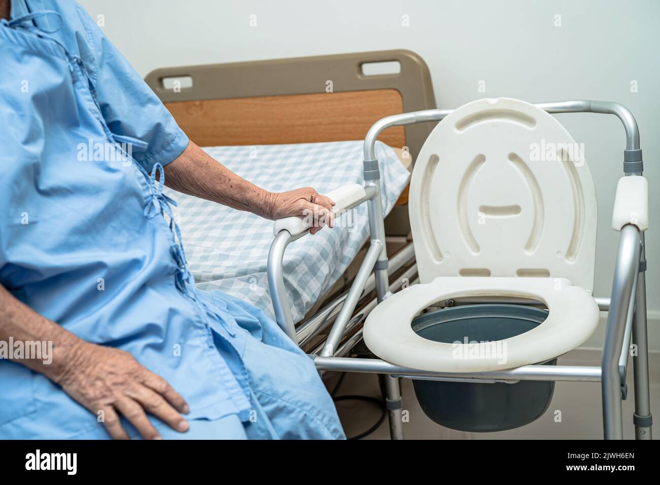 Flush toilet and shower chair in bathroom for old elder people Stock