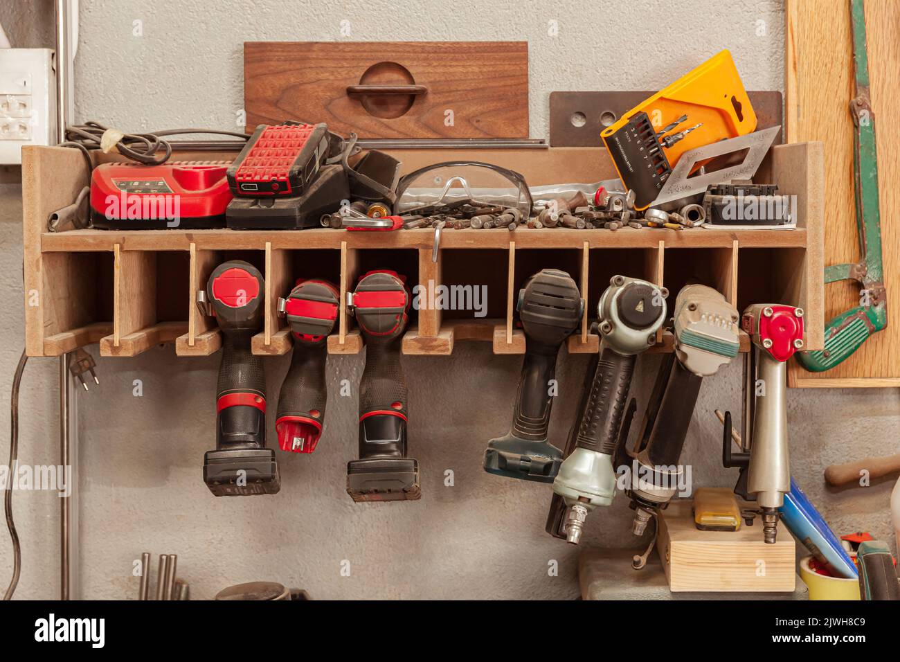 Wood workshop with many hand tools on plank wall Stock Photo