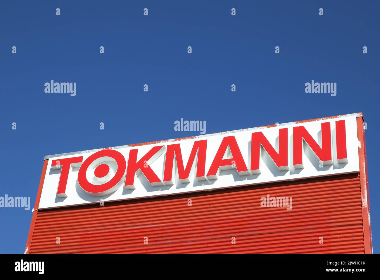 Tornio, Finland - August 29, 2022: Close-up view of the Tokmanni low-price retail chain shop logo. Stock Photo