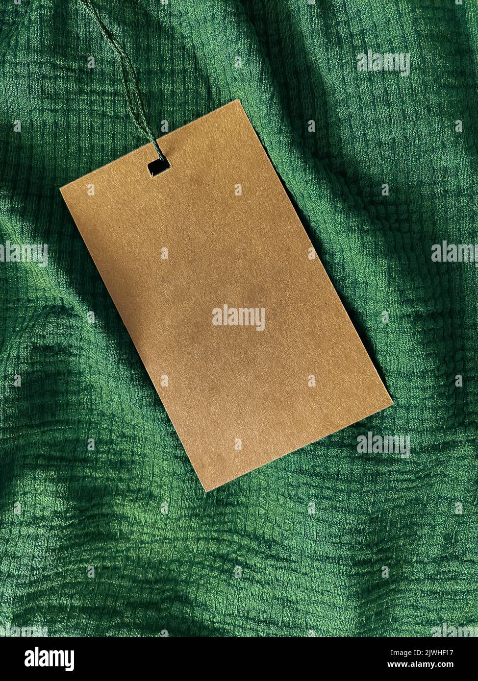 Blank fashion label tag, sale price card on luxury fabric background, shopping and retail