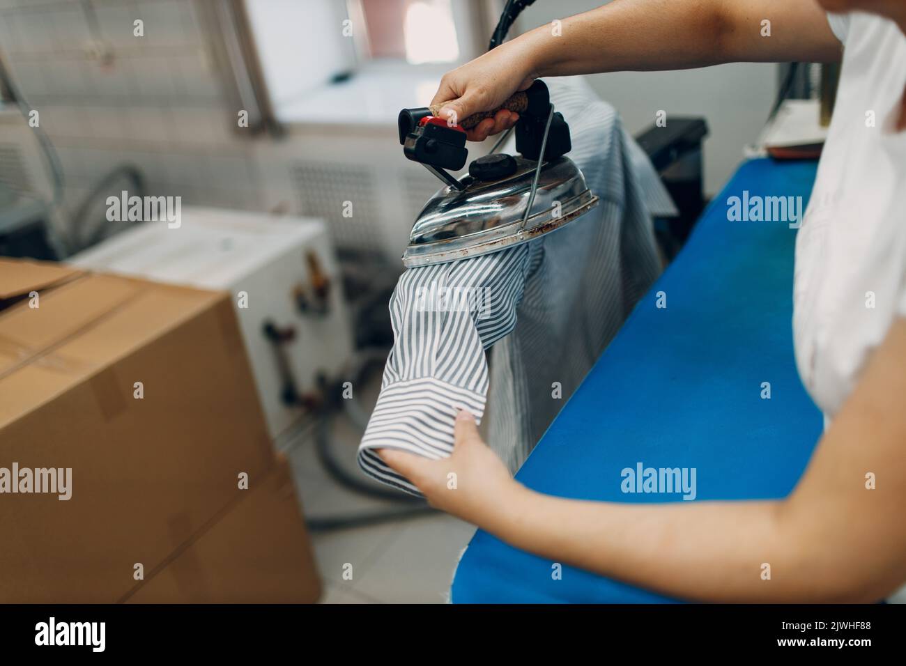 Dry cleaning ironing clothes. Clean cloth chemical process. Laundry industrial dry-cleaning. Stock Photo