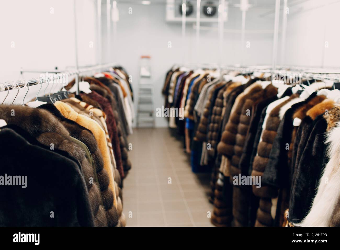 Dry cleaning clothes hanging fur coats. Clean cloth chemical process