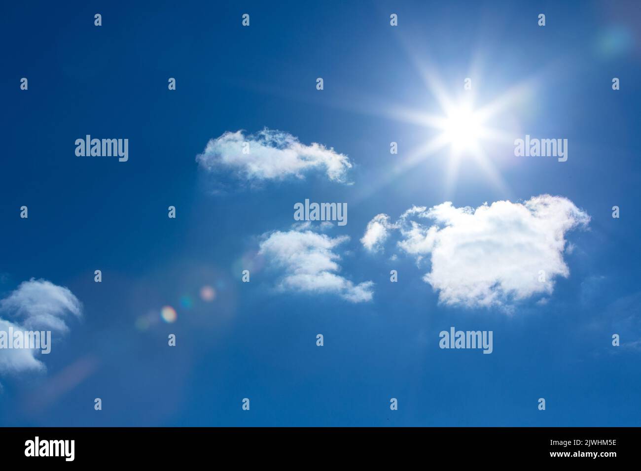 Low angle of bright blue sky with clouds Stock Photo - Alamy