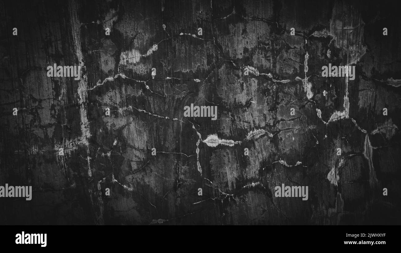 A black background of a wall with marks and a copy space great for