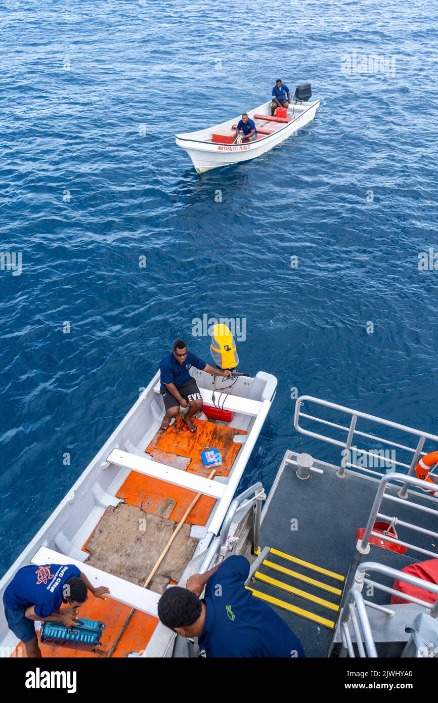 Small boat transporting tourists from the Yasawa Flyer Island Ferry to their resort, Yasawa Islands Fiji Stock Photo