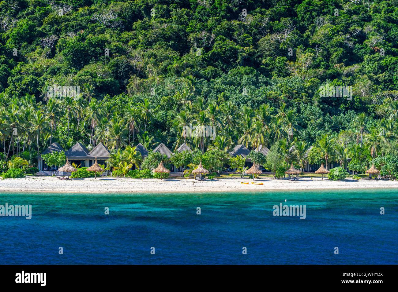 Bungalows on beach at tourist resort, Yasawa Islands, Fiji Stock Photo