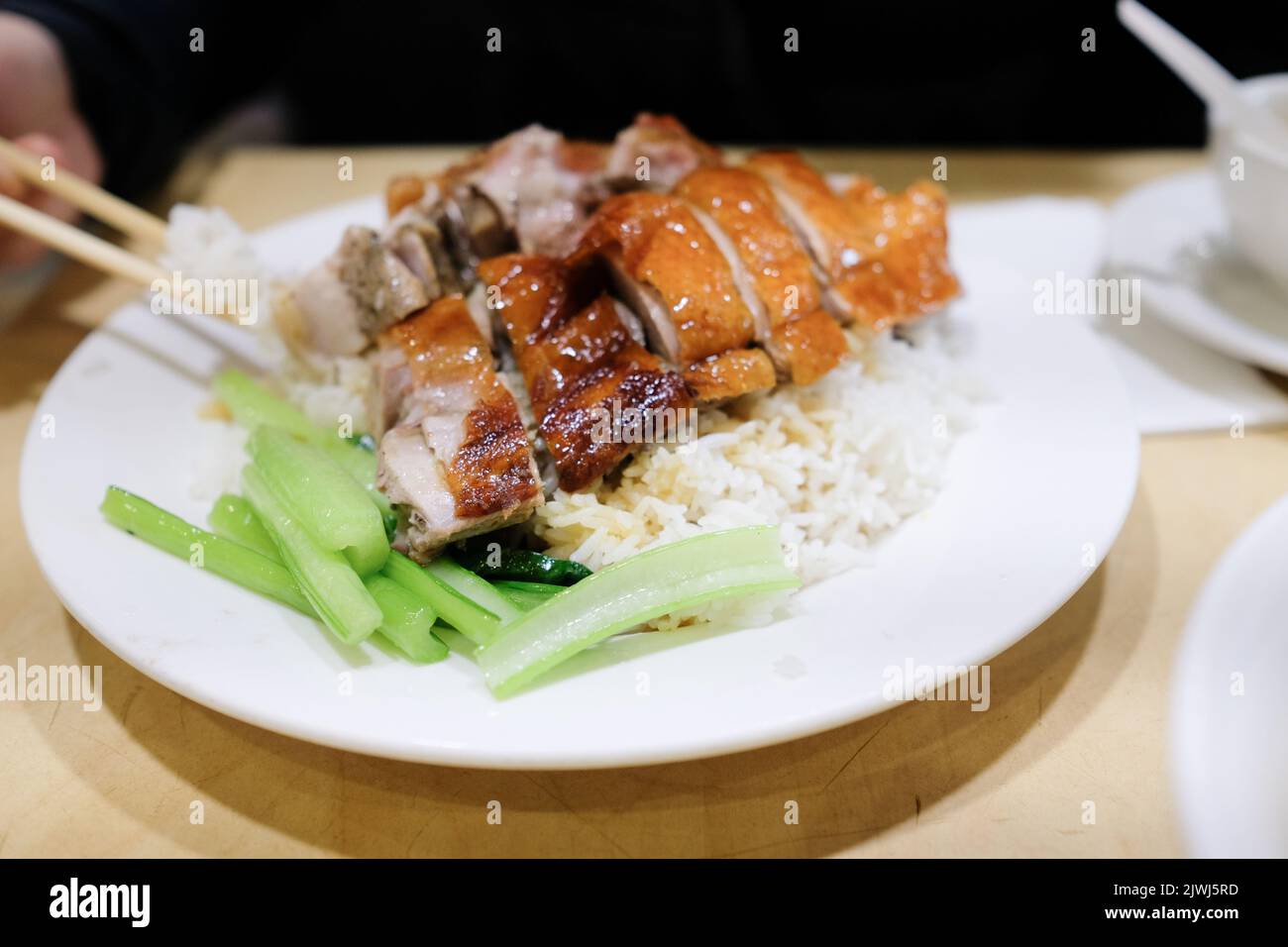 A plate of roast duck with rice and steamed greens at BBQ One, a Cantonese restaurant in Eastwood — Sydney, Australia Stock Photo