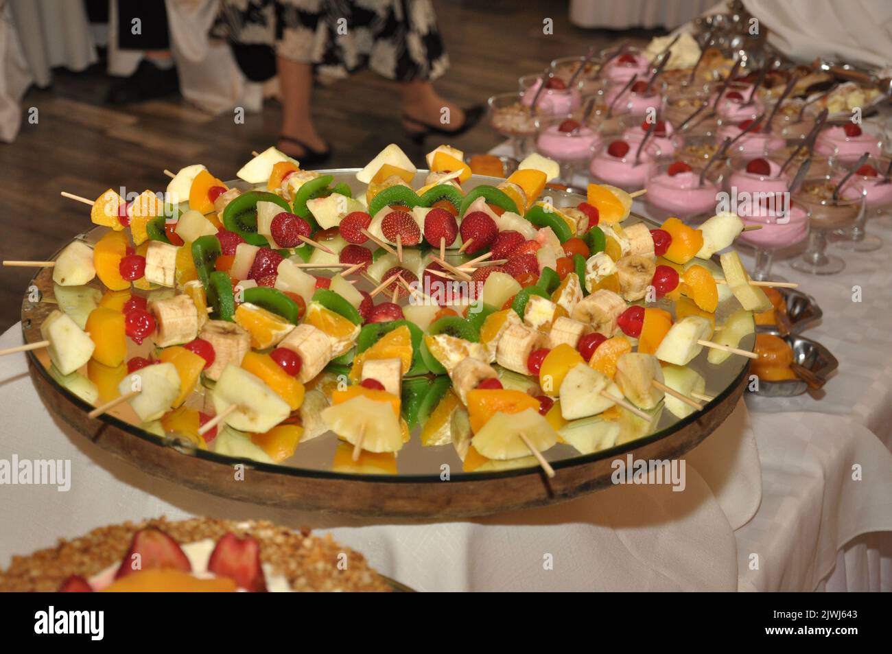 A selective focus shot of a platter of fruit skewers on a dessert buffet table Stock Photo