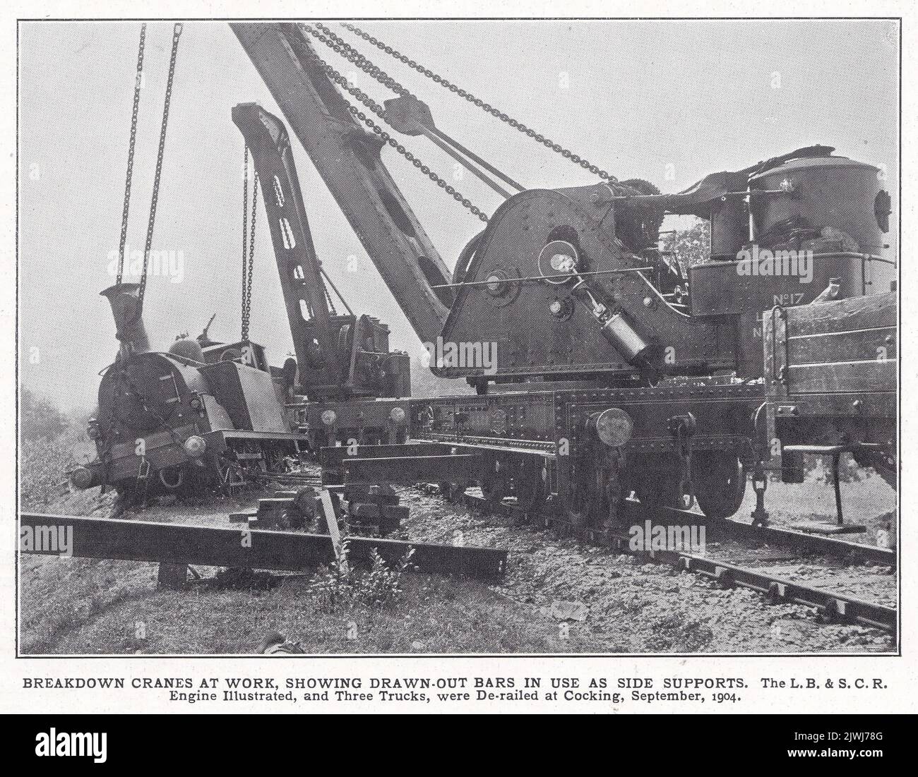 The L. B. & S. C. R. engine and trucks derailed at Cocking 1904.  Breakdown cranes at work showing drawn out bars in use as side supports. Stock Photo
