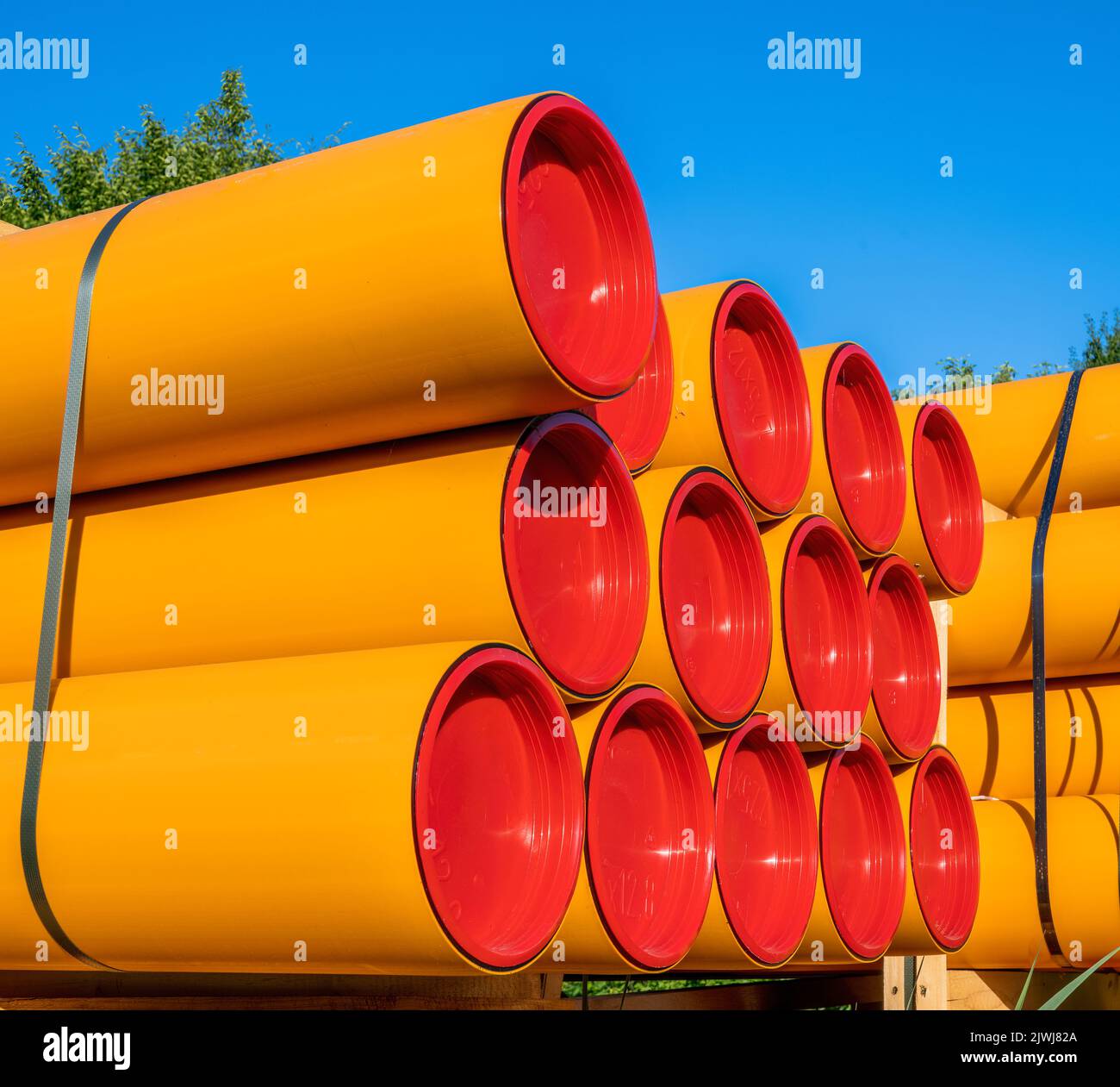 Pile of orange pvc protective pipes Stock Photo